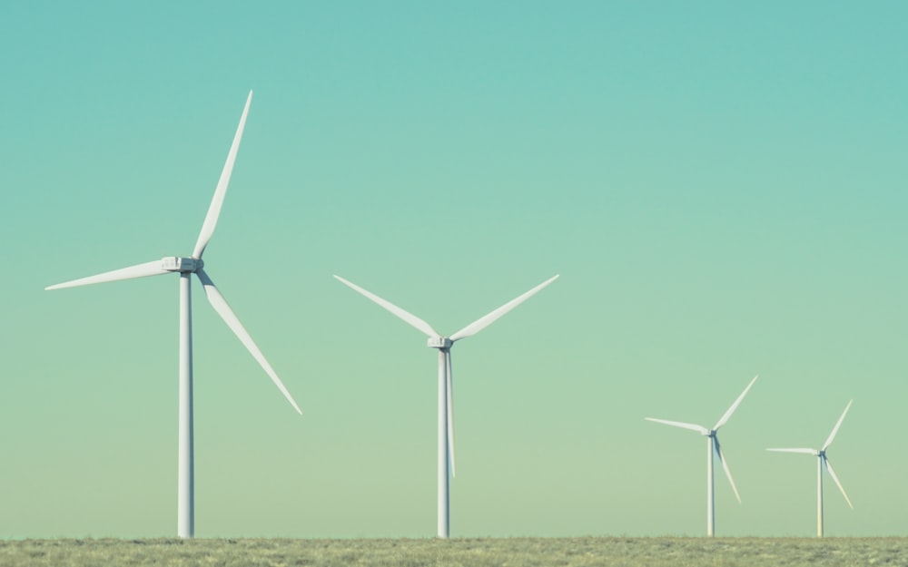 a group of wind turbines in a field