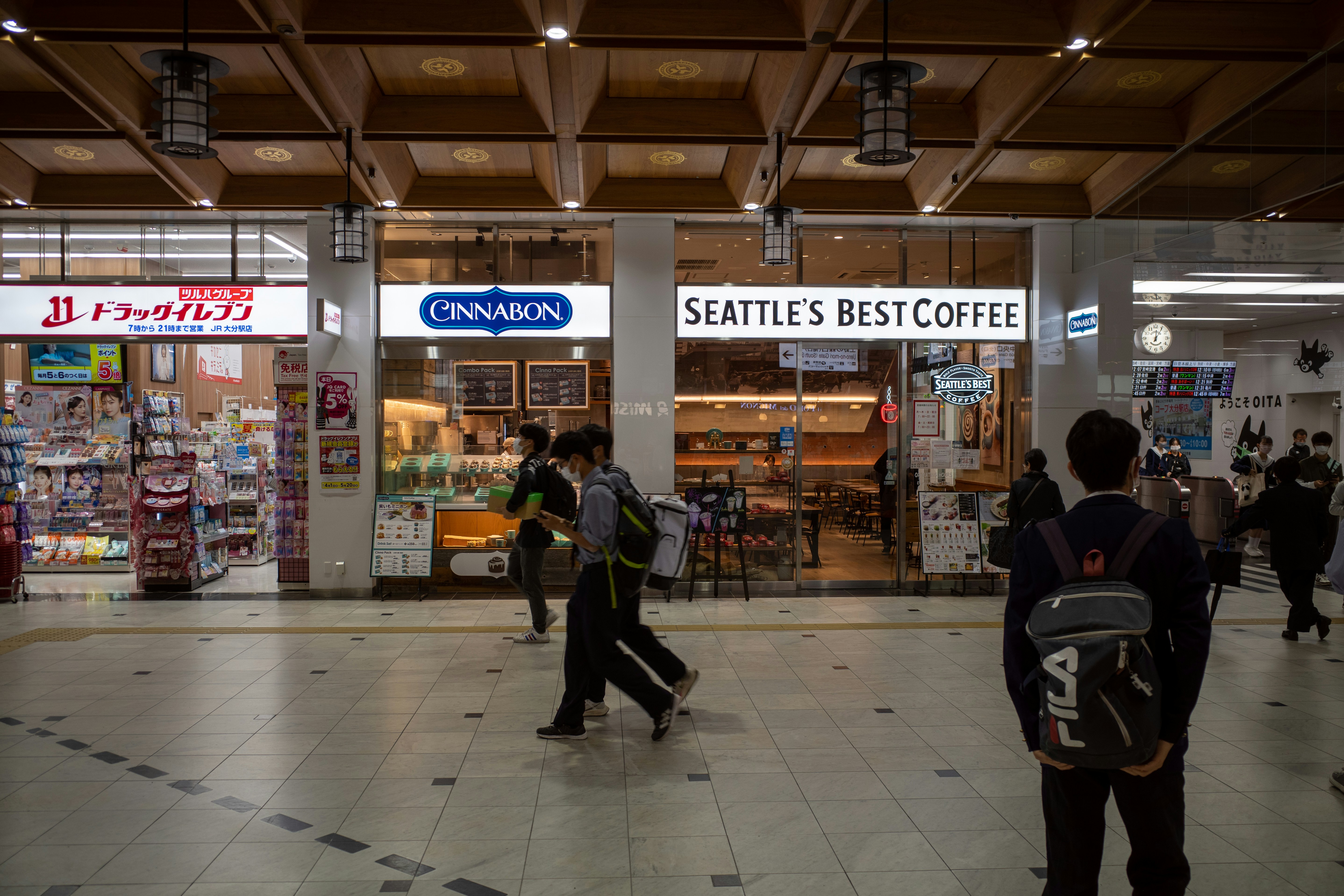 A group of people walking inside of a store photo – Free Human Image on ...