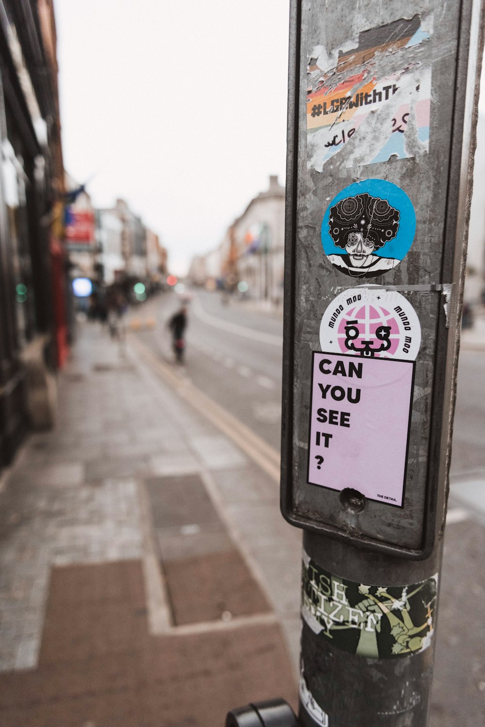 a pole with a bunch of stickers on it