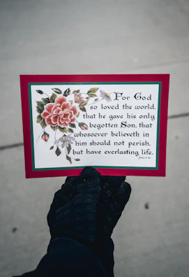 Hands gently holding a free downloadable prayer card with a heartfelt scripture.
