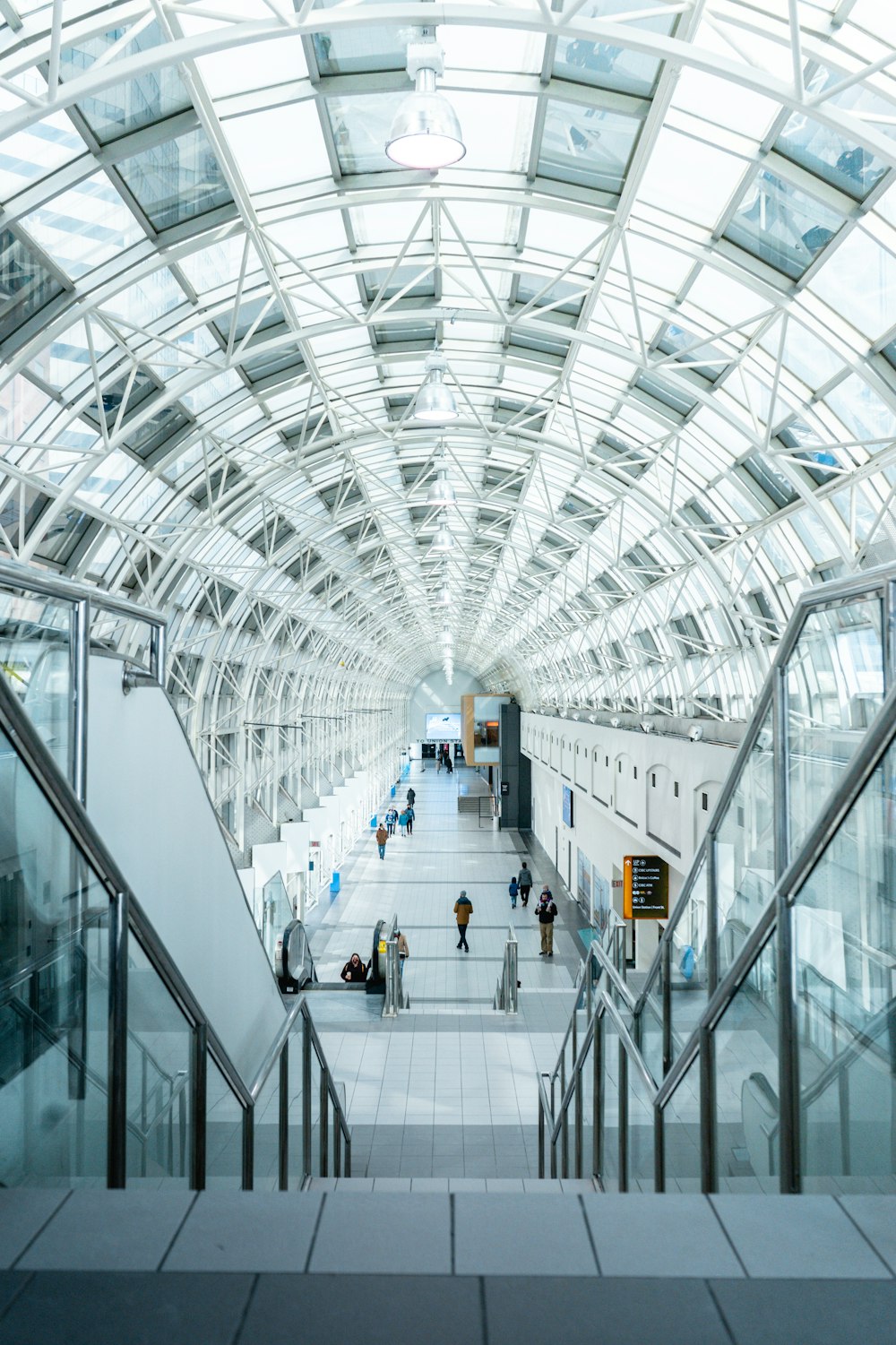 a walkway inside of a building with a skylight