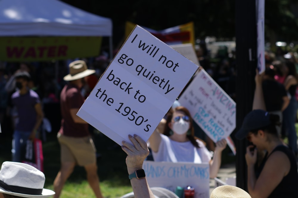 a group of people holding up signs in the air