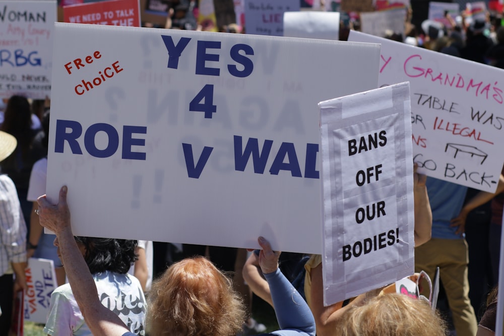 a group of people holding up signs in the air