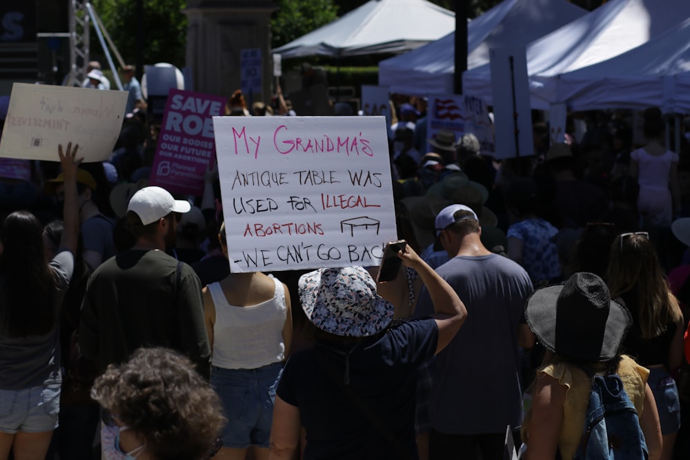 a group of people holding up a sign