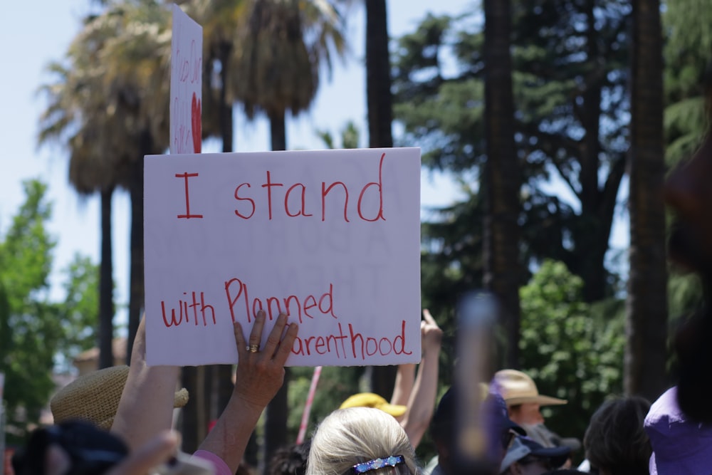 a group of people holding up signs in the air