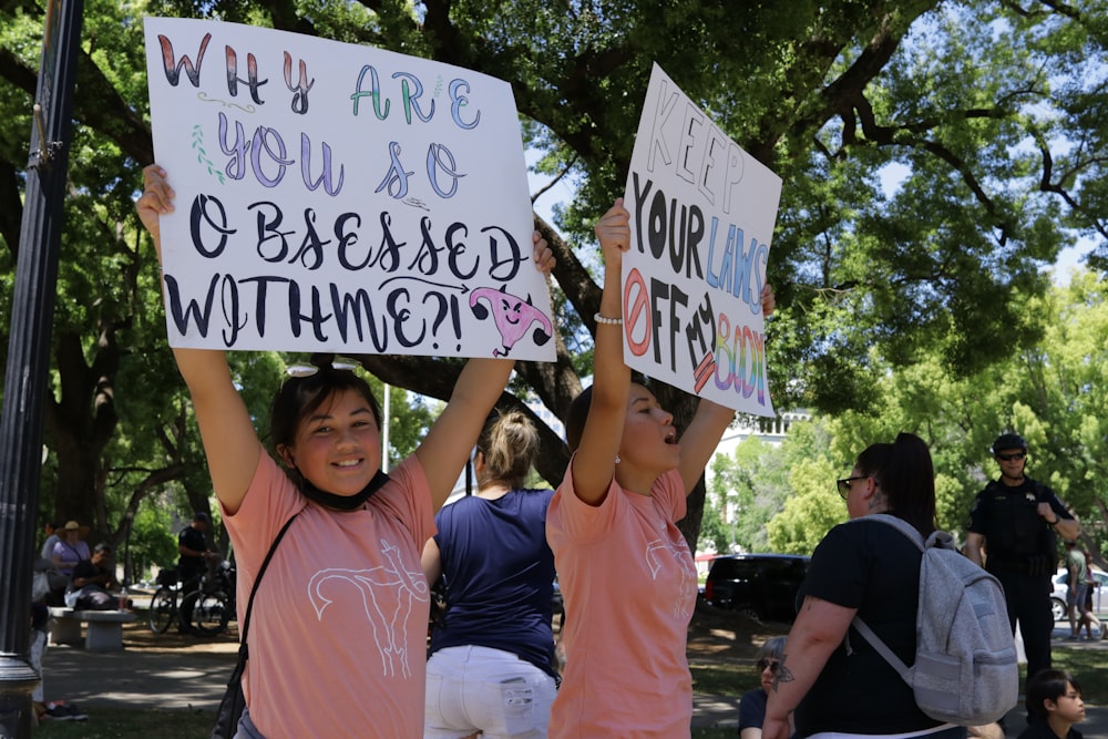 a group of people holding up signs in the air