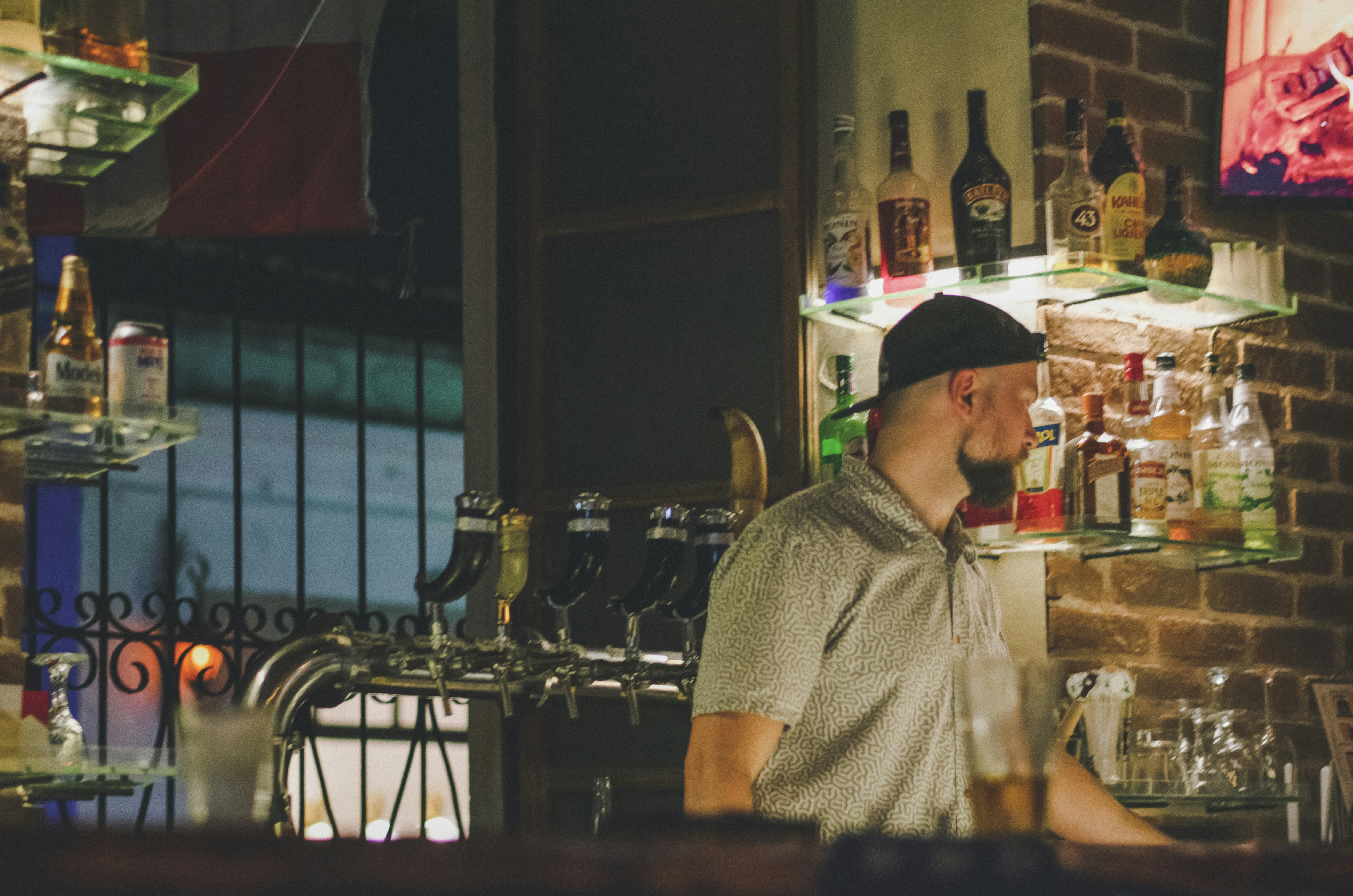 a man standing at a bar in a restaurant