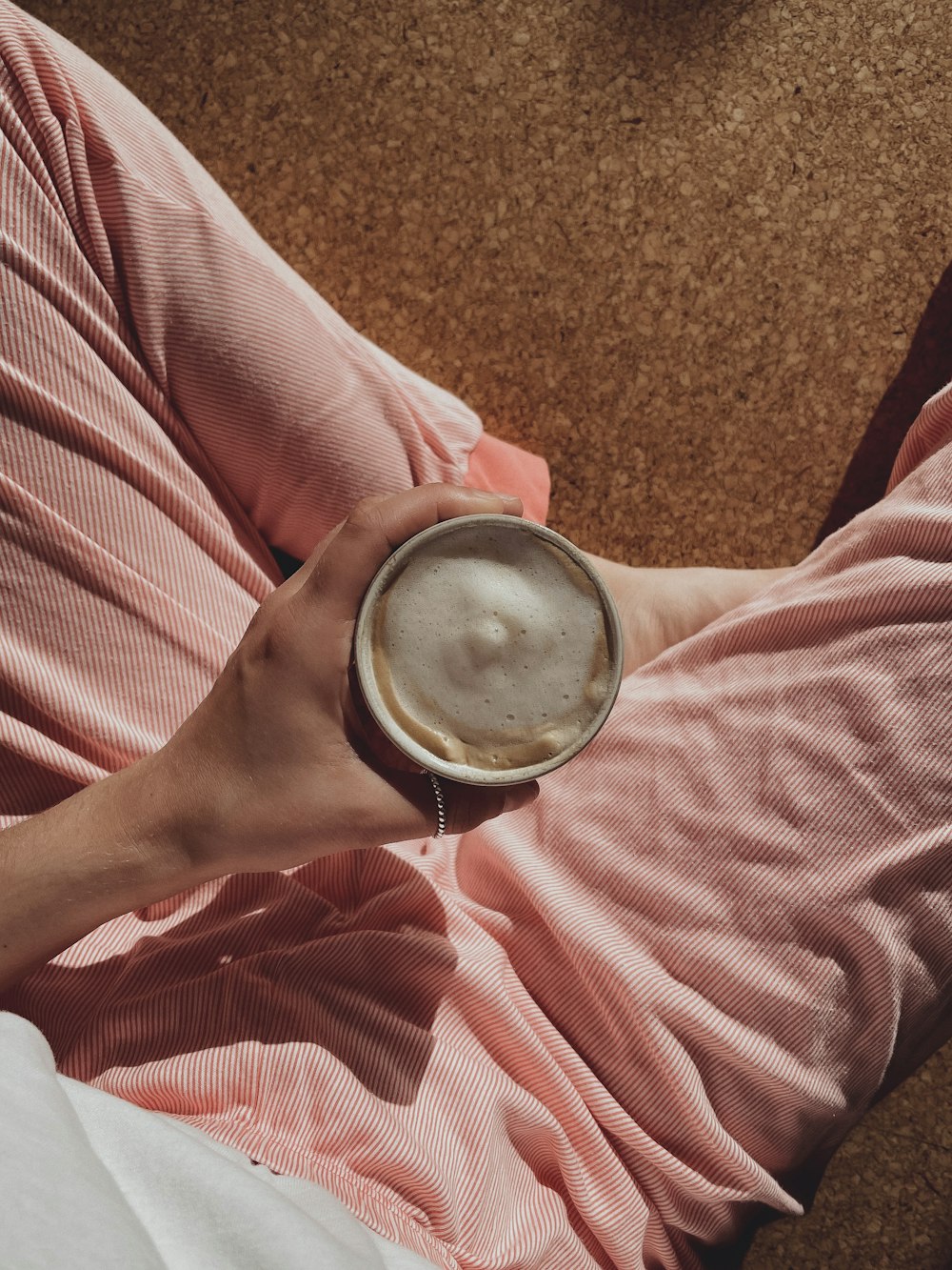 a person is holding a cup of coffee