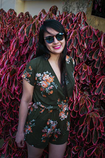 A vibrant outdoor scene with a model wearing a colorful eco-friendly outfit amid green foliage