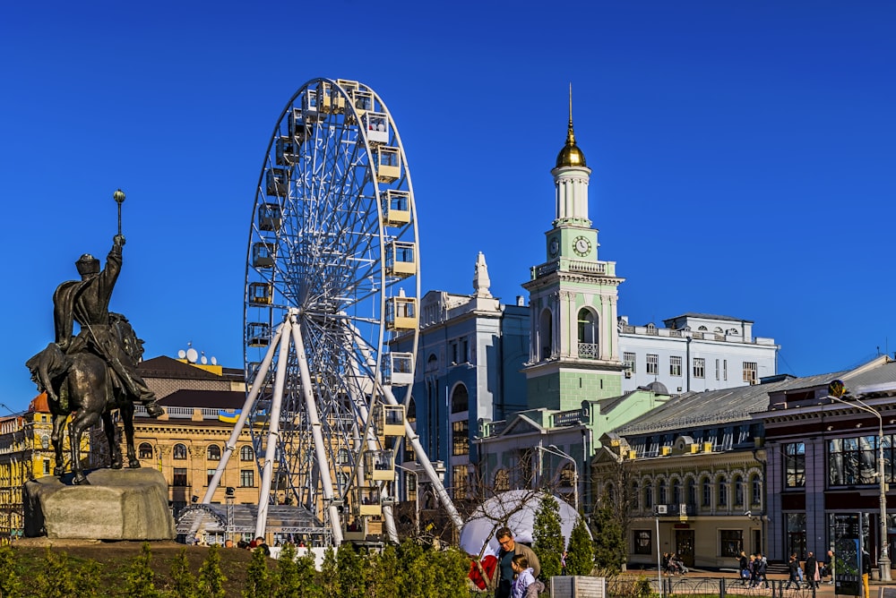 a large ferris wheel sitting next to a tall building