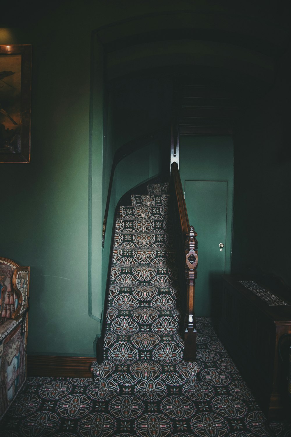 a stair case in a room with green walls