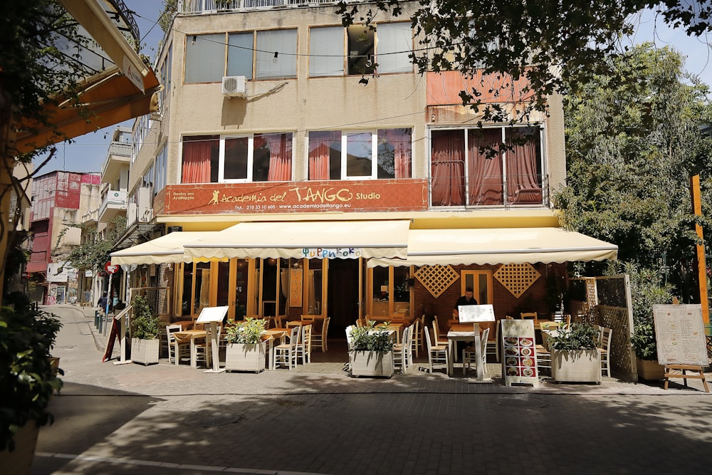 a building with a bunch of tables and chairs in front of it