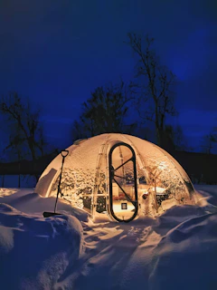 a snow covered building with a bike rack in front of it