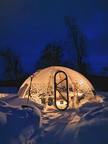 a snow covered building with a bike rack in front of it
