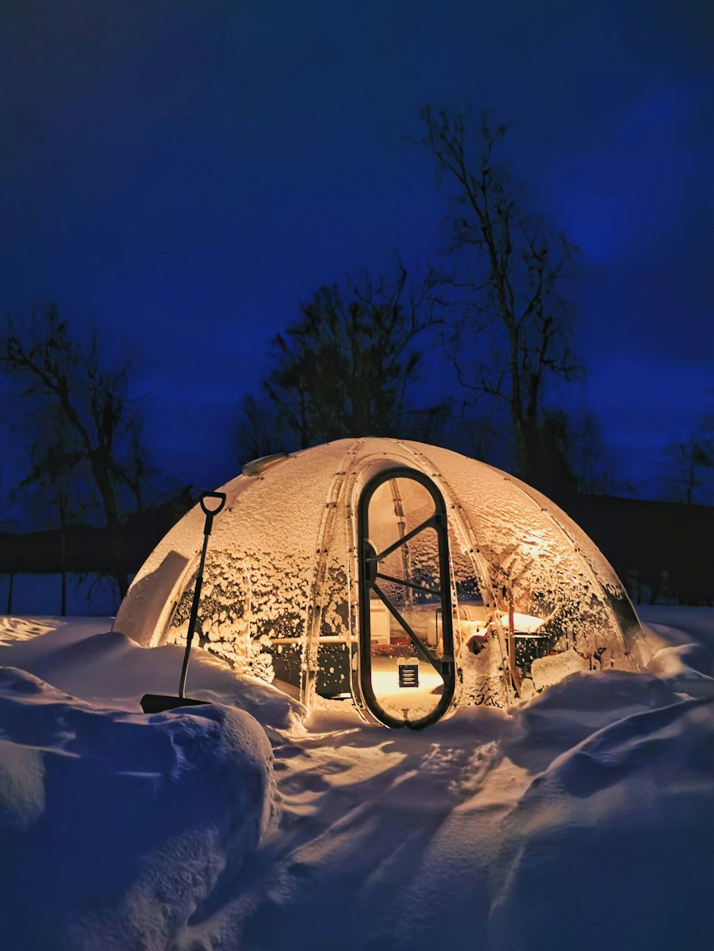 a snow covered building with a bike rack in front of it