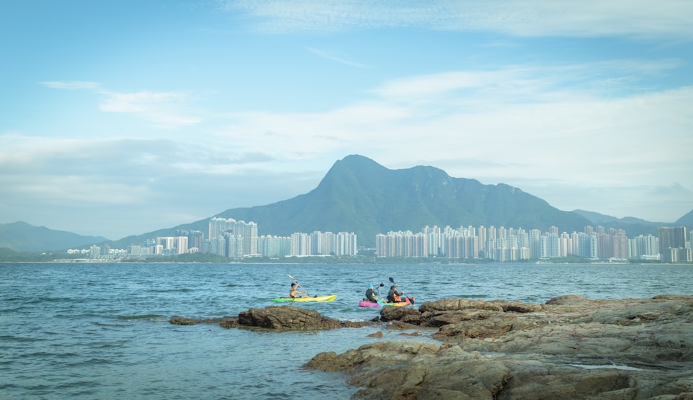 a group of people riding kayaks on top of a body of water