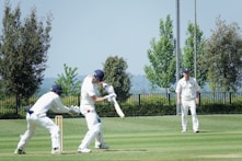 a group of men playing a game of cricket