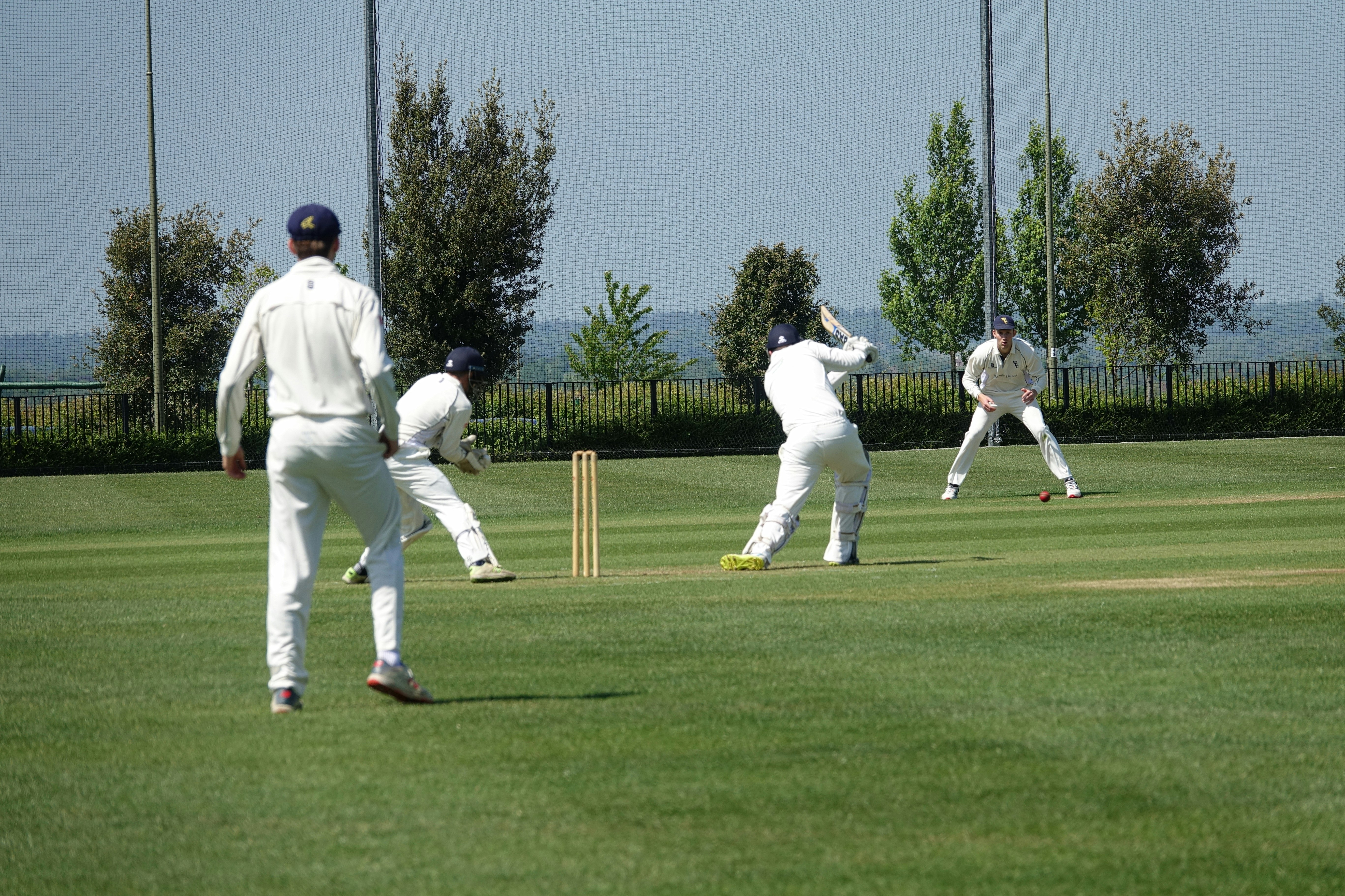 a group of men playing a game of cricket