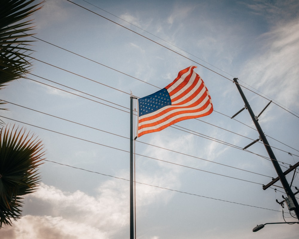 an american flag is flying on a pole