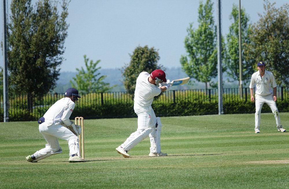 a group of men playing a game of cricket