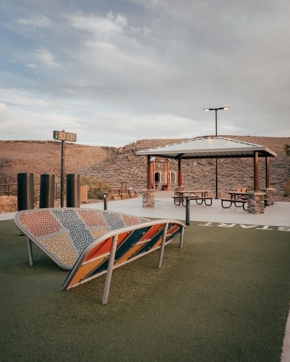 a bench sitting on top of a grass covered field