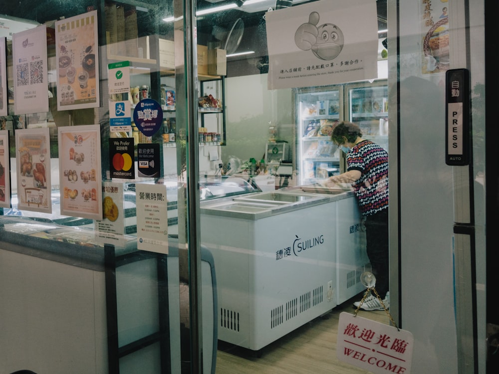 a person standing at a counter in a store