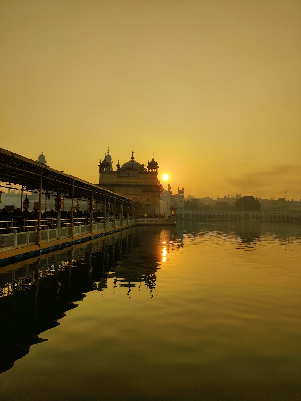 a large body of water with a building in the background