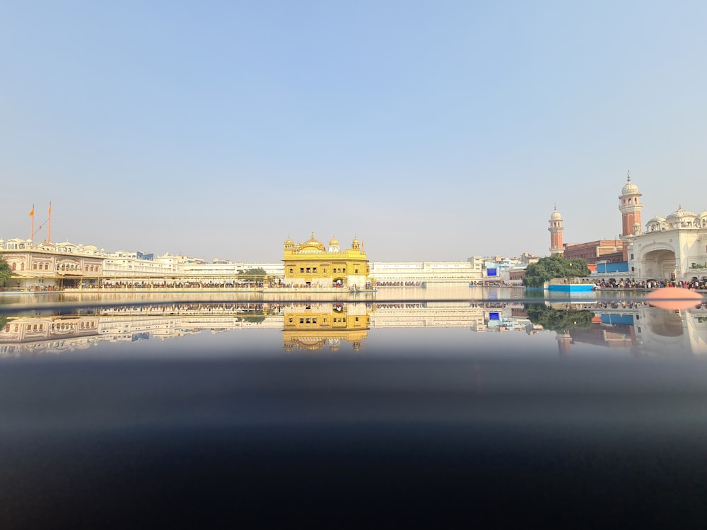 a large body of water with buildings in the background