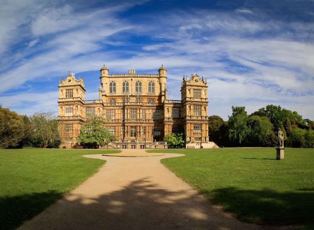 a large building sitting on top of a lush green field