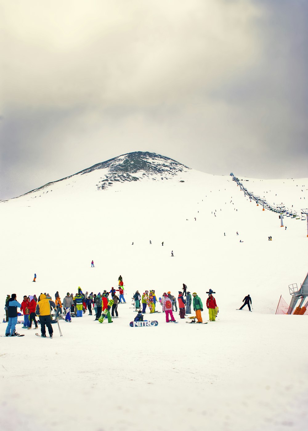 a group of people standing on top of a snow covered slope