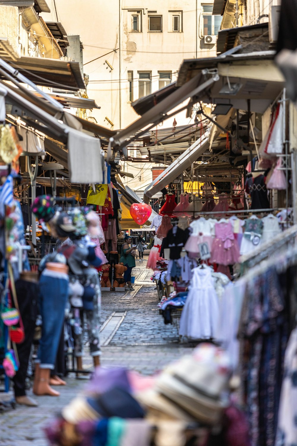 a street market with people shopping in it