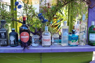 a purple table topped with lots of bottles of liquor