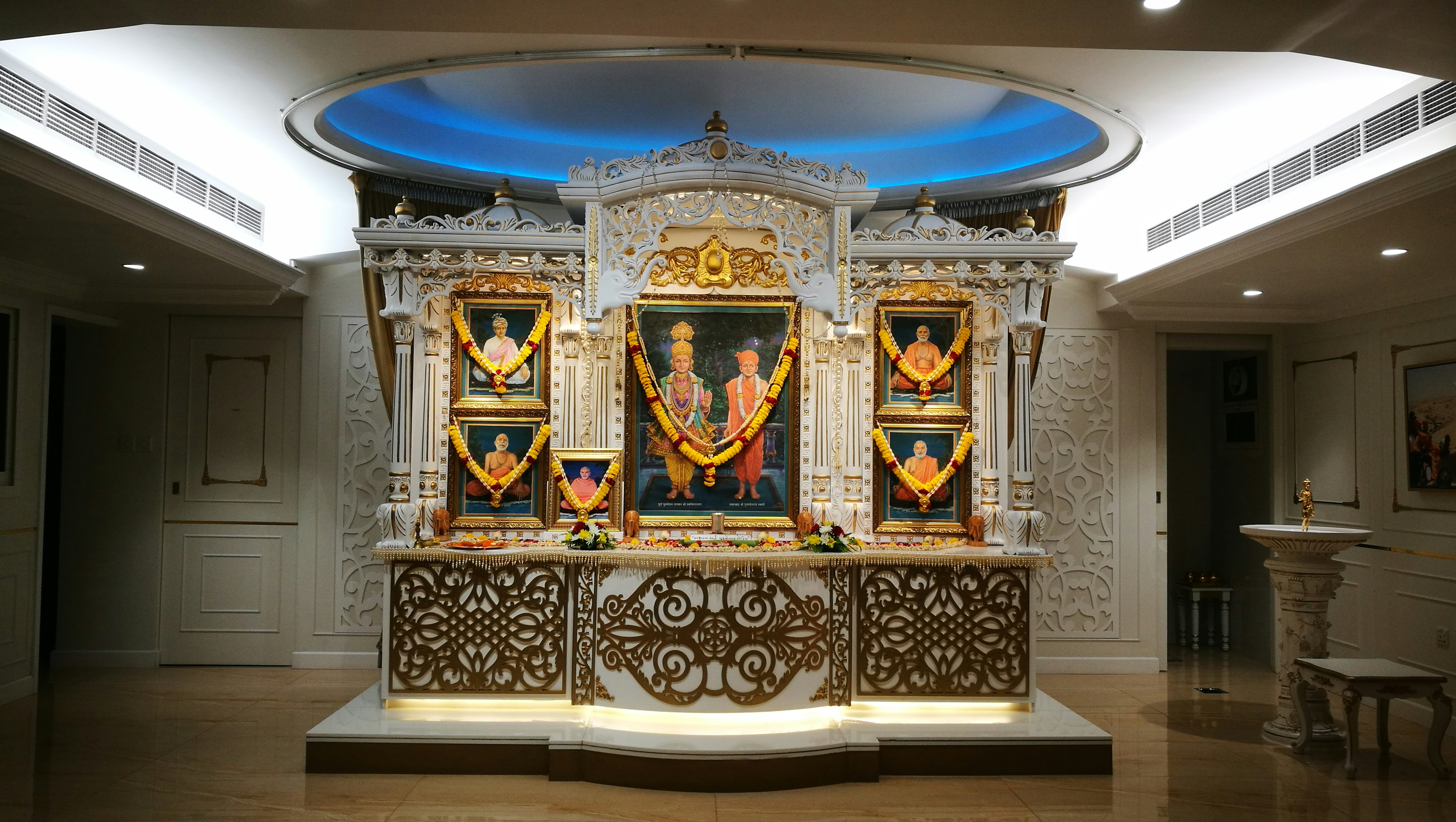 a shrine in a large room with a blue ceiling