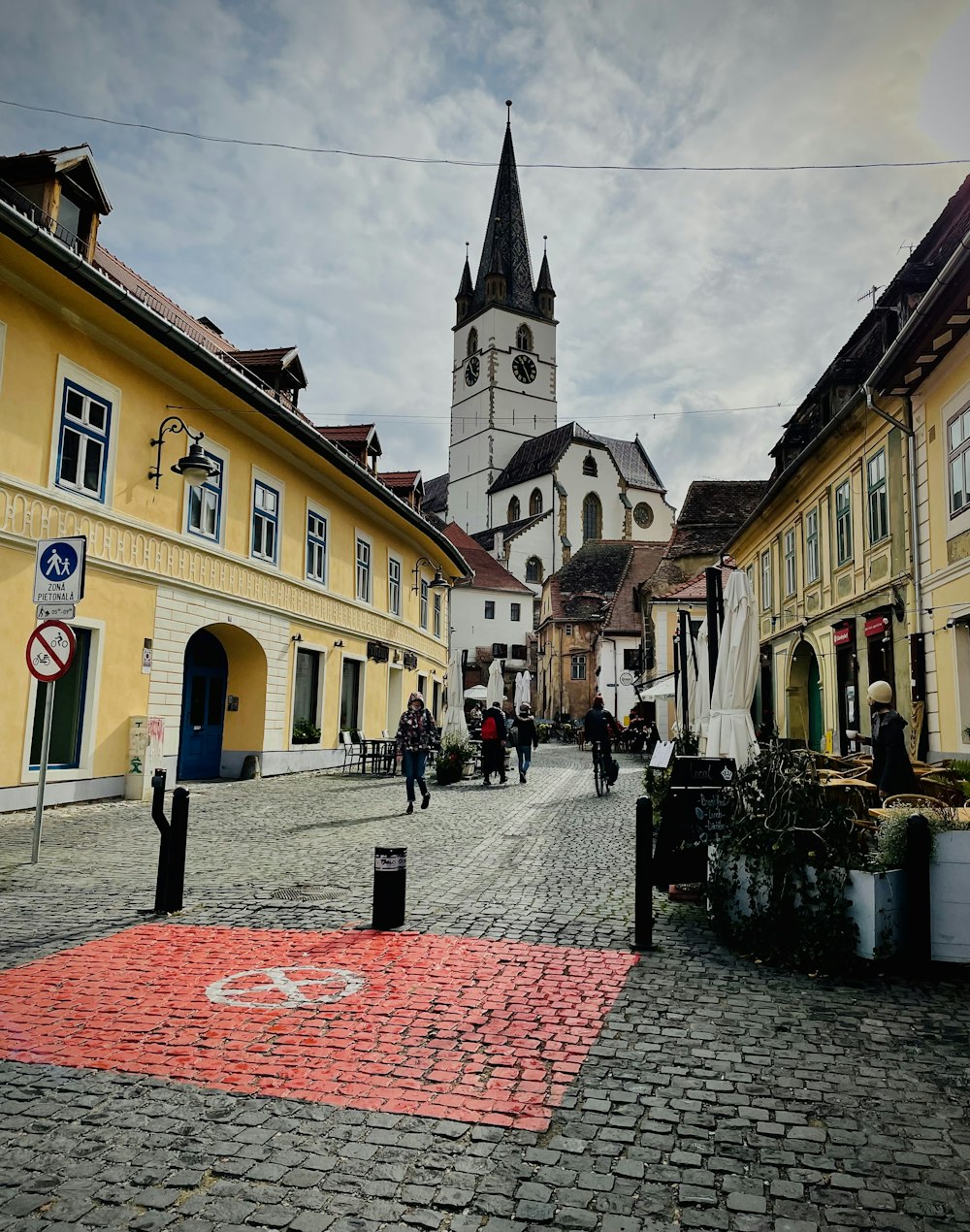a cobblestone street with a church in the background