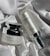 Two skincare product bottles are displayed on a textured, white fabric surface. One is a round jar labeled 'Multi Tea Serum', featuring a shiny silver lid. The other is a cylindrical bottle labeled 'Advanced Night Booster', also with silver accents.