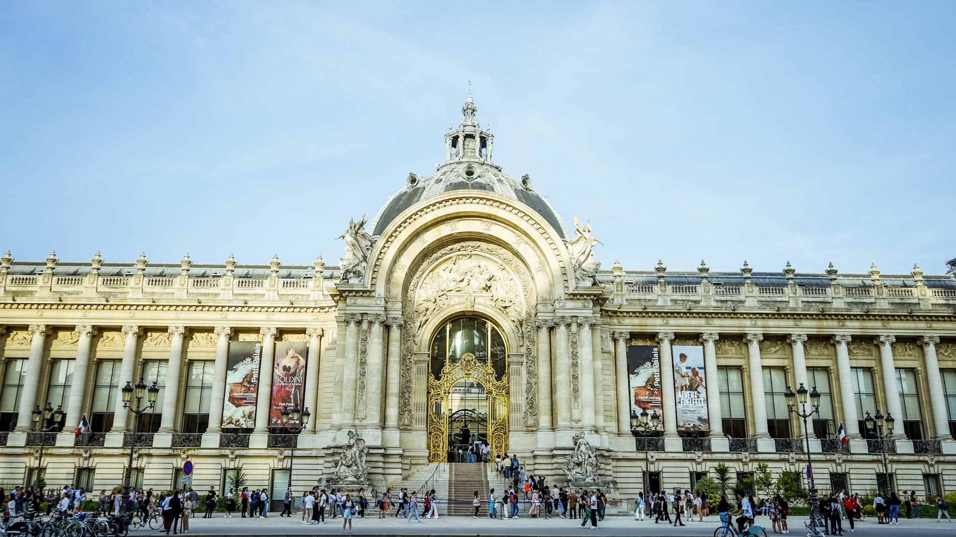 a large building with a lot of people walking around it
