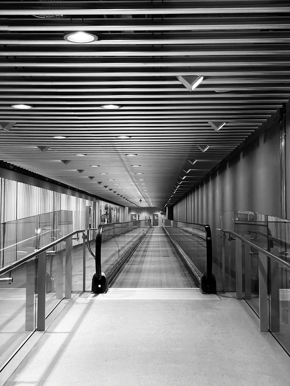 a black and white photo of a long hallway