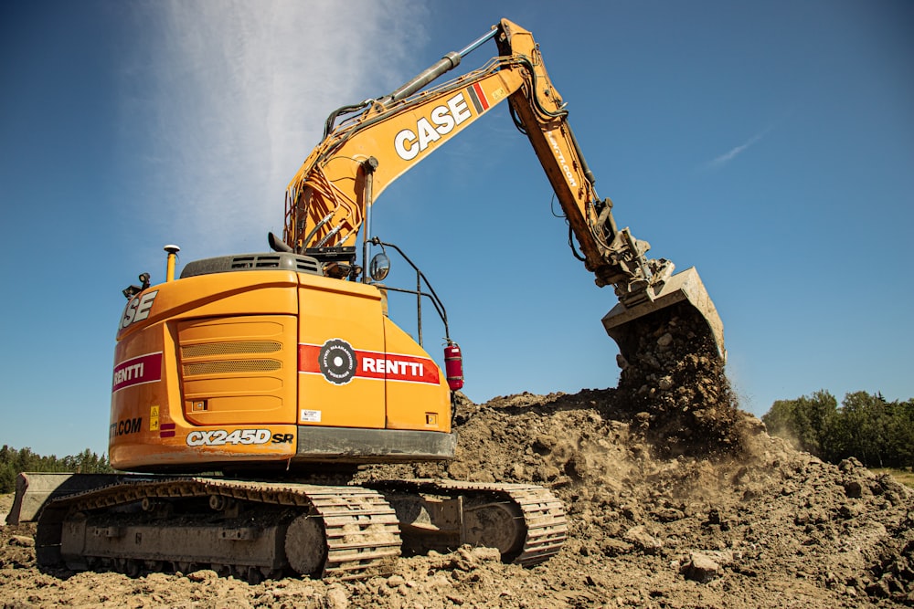 a yellow and black construction vehicle and some dirt