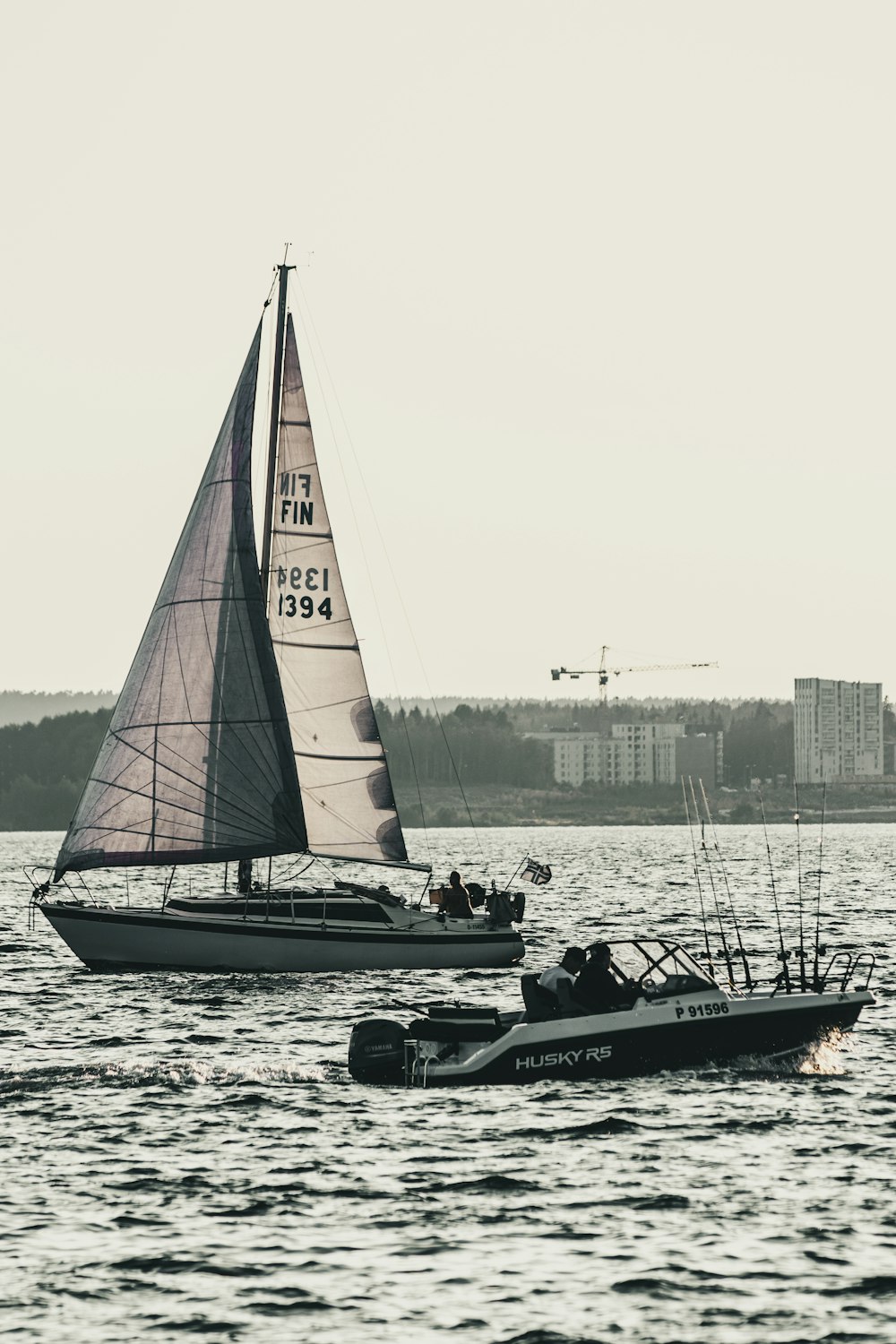 a couple of boats floating on top of a body of water