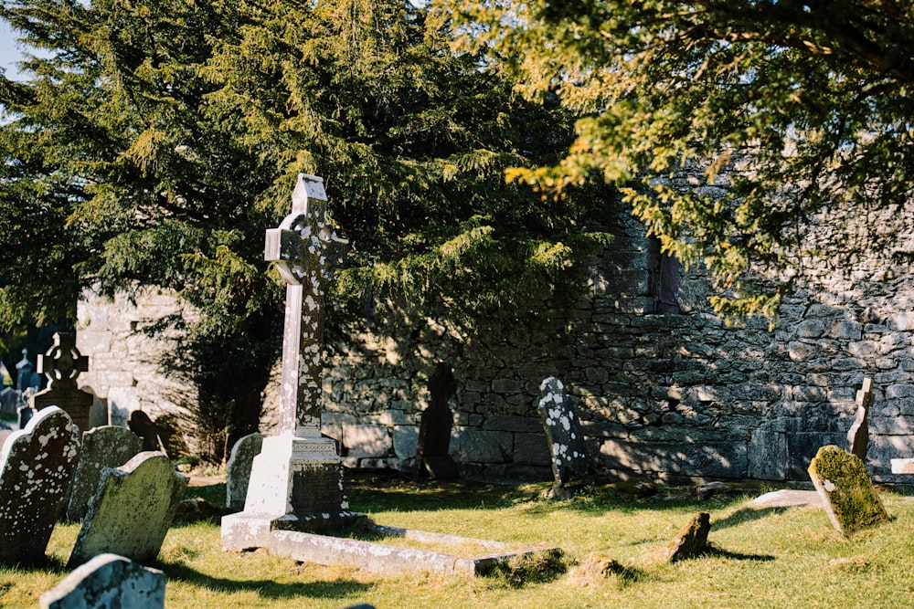 a cemetery with a stone wall in the background