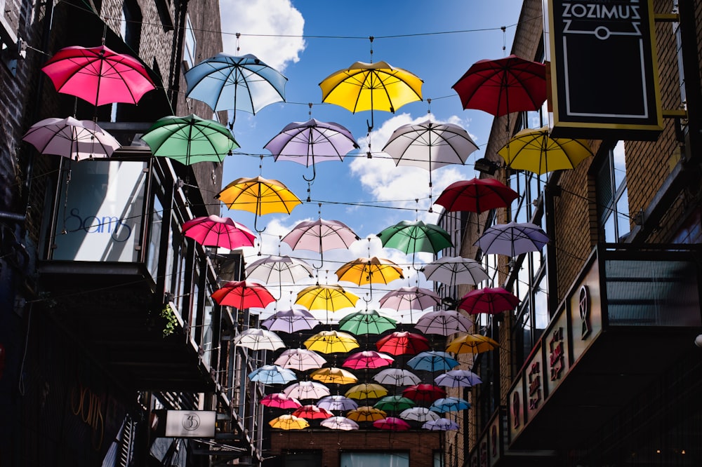 a group of colorful umbrellas hanging from a building