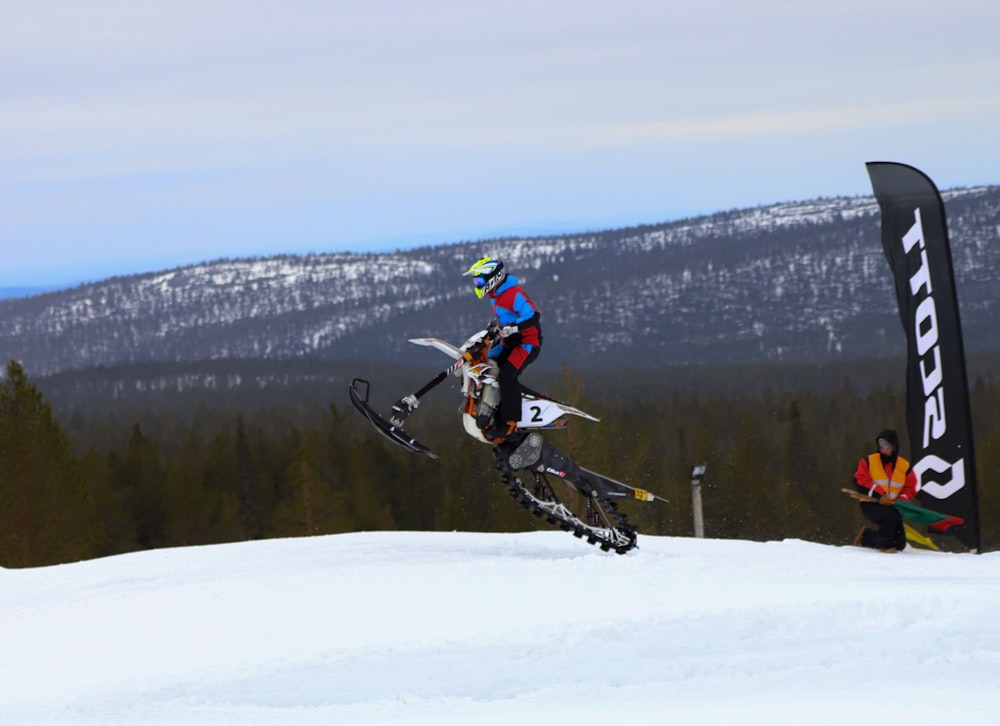 a person jumping a snow board in the air