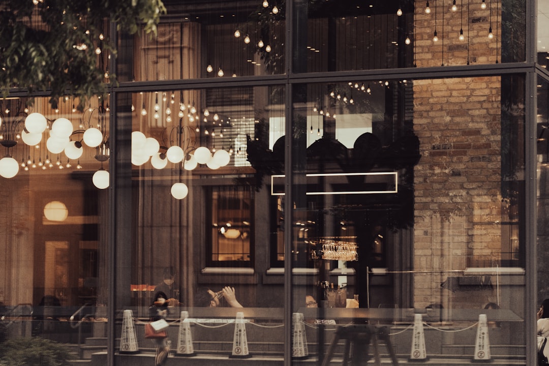 the reflection of people walking in the window of a store,