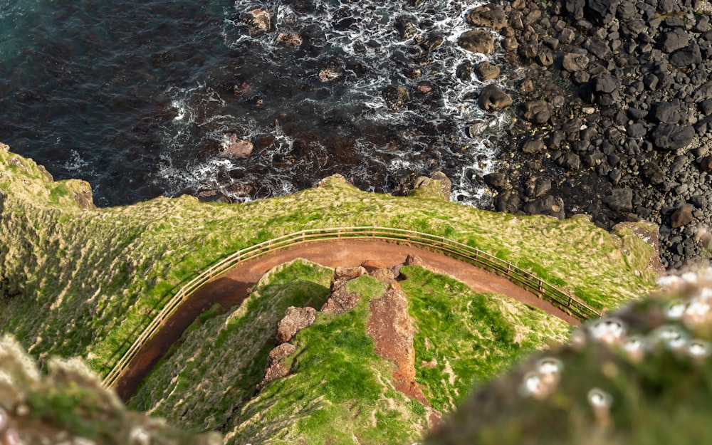 an aerial view of the ocean and a bridge