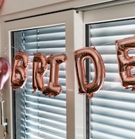 a balloon that says happy birthday hanging from a window