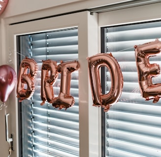 a balloon that says happy birthday hanging from a window