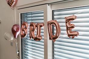 a balloon that says happy birthday hanging from a window