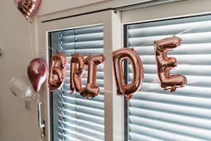 a balloon that says happy birthday hanging from a window