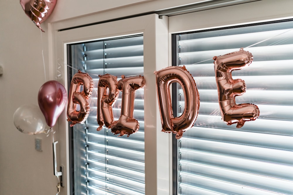 a balloon that says happy birthday hanging from a window