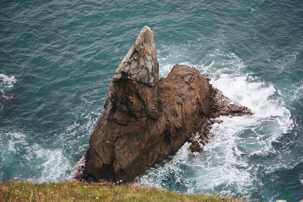 a large rock sticking out of the ocean